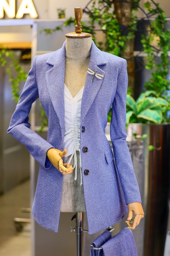 Elegant lilac jacket on a mannequin in boutique setting, showcasing chic fashion.